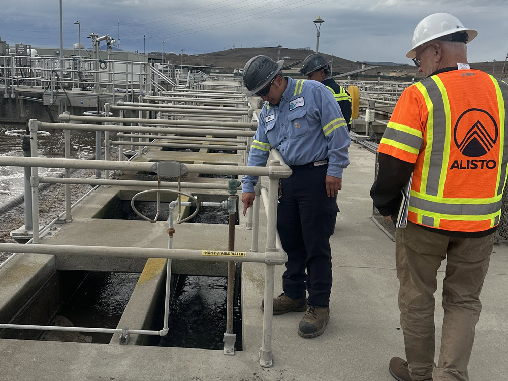 Alisto team in safety vests and hard hats inspecting a water treatment plant
