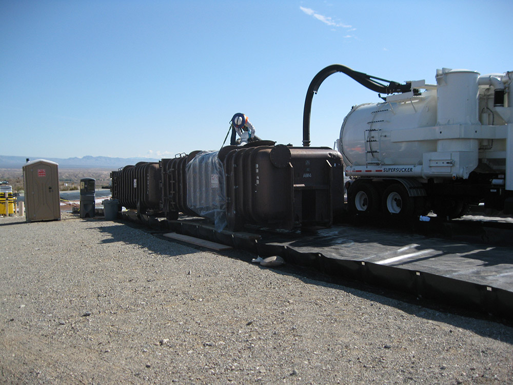 Sludge clean up using a vac truck on a construction site